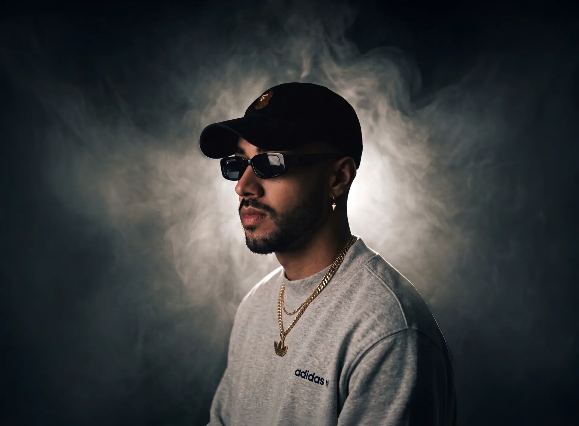 Jiffy Trice wearing a cap and sunglasses