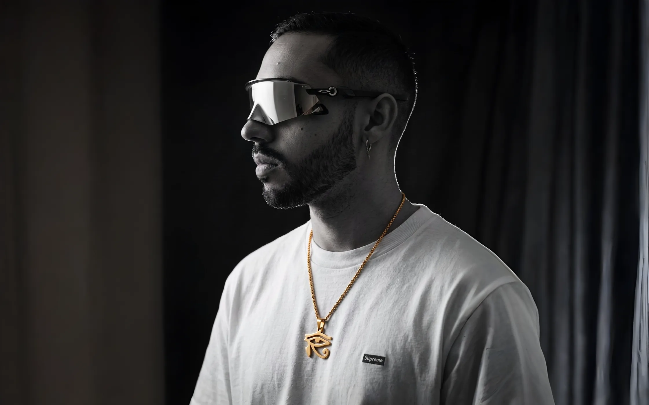 Jiffy Trice wearing visor sunglasses in a black and white portrait